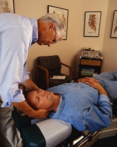 Chiropractor Adjusting Patient's Neck